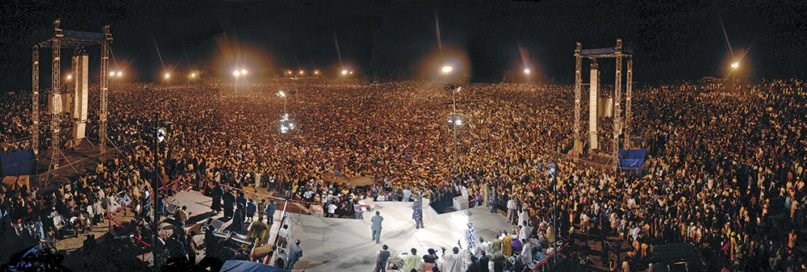 A large crowd surrounds the stage as Reinhard Bonnke holds a crusade in 2006 in Africa.