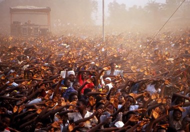 People wave their arms during a 1991 Reinhard Bonnke crusade in Zaire.