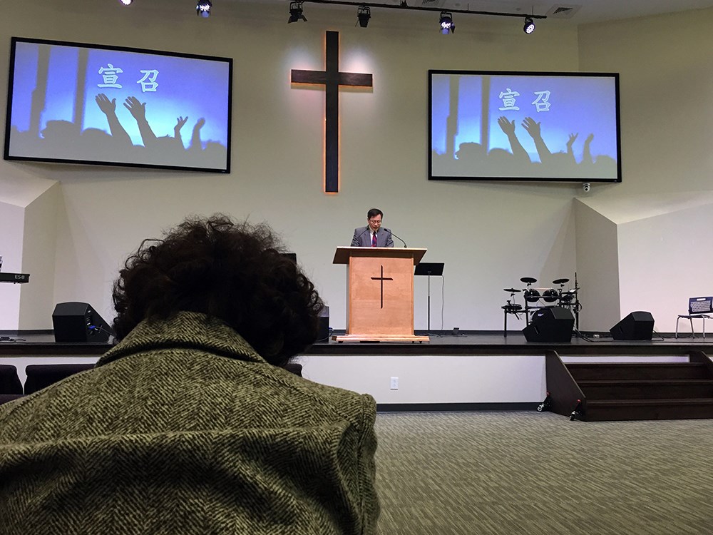 A Chinese American woman bows her head in prayer at Raleigh Chinese Christian Church on Feb. 23 in Cary, North Carolina.