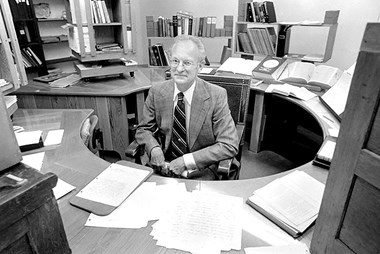 Paul Jewett at the infamous round table he had built for his office.