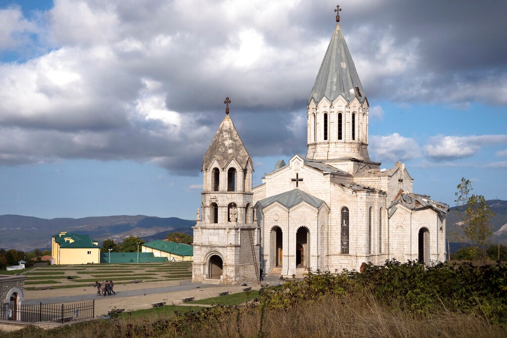 Men carry out furniture from the Holy Savior Cathedral damaged by shelling during a military conflict, in Shushi, outside Stepanakert, self-proclaimed Republic of Nagorno-Karabakh on October 8.