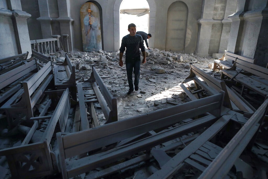 A man walks in rubbles of the Ghazanchetsots (Holy Saviour) Cathedral in the city of Shusha, some 15 kilometers from the Nagorno-Karabakh province's capital Stepanakert on October 8.