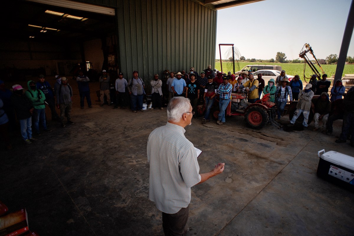 Tom Rios preaches to agriculture workers at a barbeque at Kingsburg Orchards near Fresno, California. CLICK TO SEE MORE IMAGES