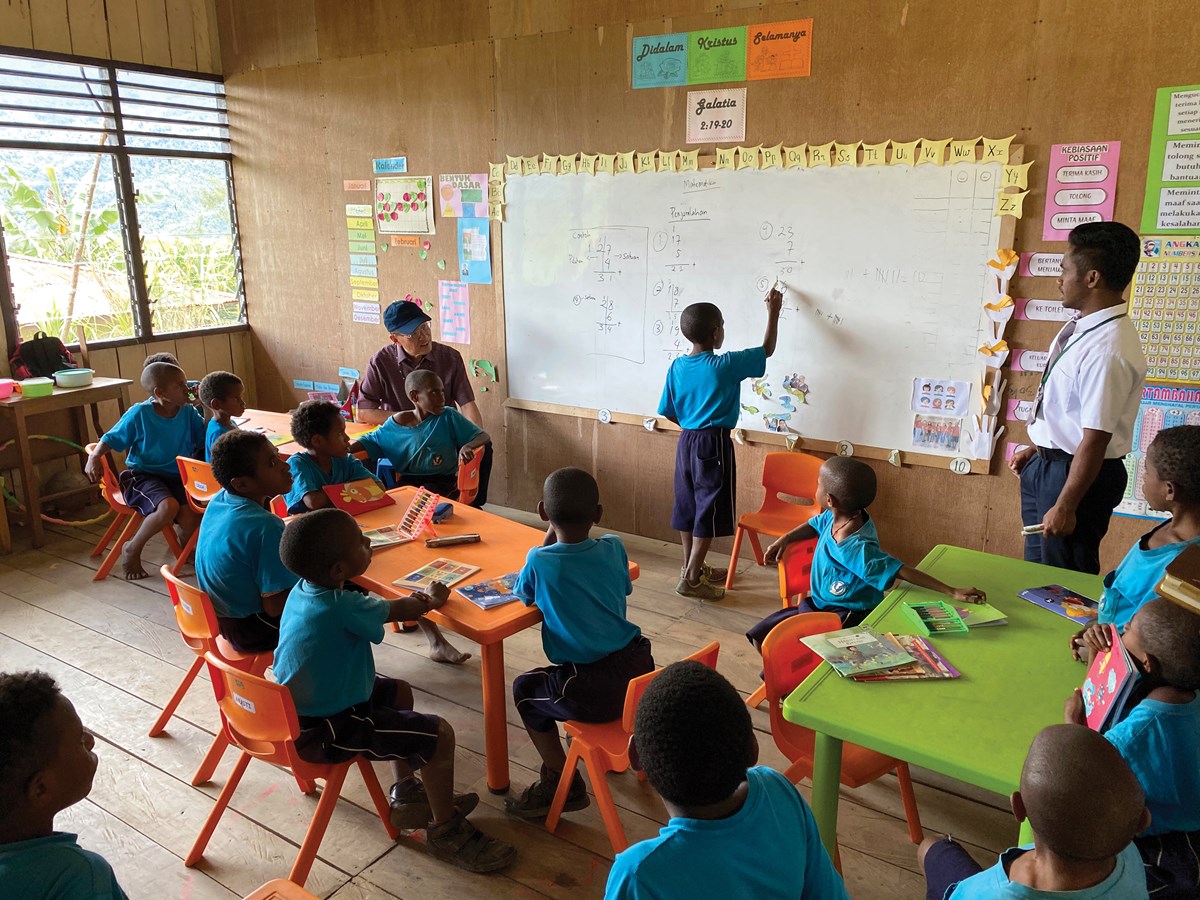 YPHP founder James Riady joins Mek students in Nalca for a math class.