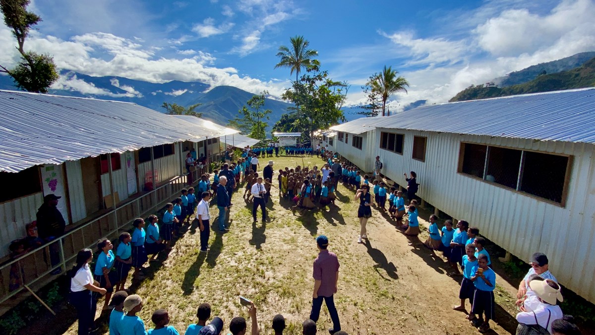 James Riady (bottom center) observes a student assembly in Mamit celebrating 100 days of class at YPHP’s largest school.