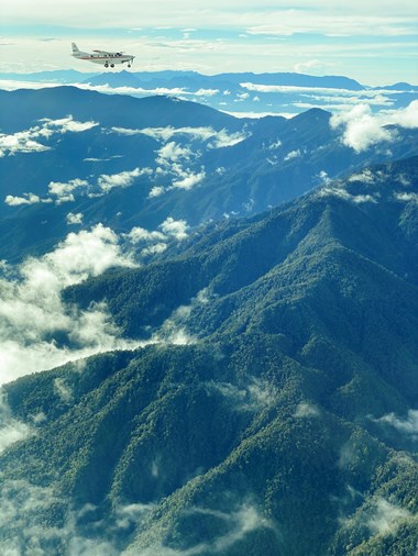 An MAF plane flies to Mamit in the mountainous interior of Papua.