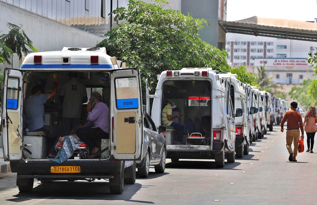 Ambulances carrying COVID-19 patients line up waiting for their turn to be attended to at a dedicated COVID-19 government hospital in Ahmedabad, India, on April 22. Ambulances carrying COVID-19 patients line up waiting for their turn to be attended to at a dedicated COVID-19 government hospital in Ahmedabad, India, on April 22.