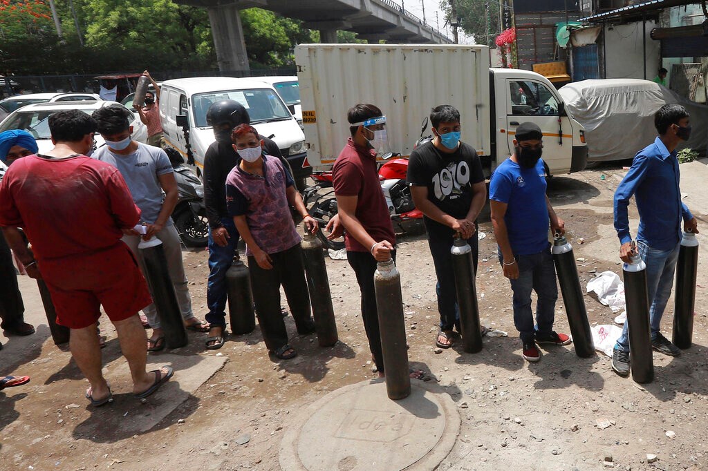 People stand in queues to refill oxygen in cylinders in New Delhi, India, on April 23. Scores have died in hospitals in India’s capital amid suggestions that low oxygen supplies were to blame.