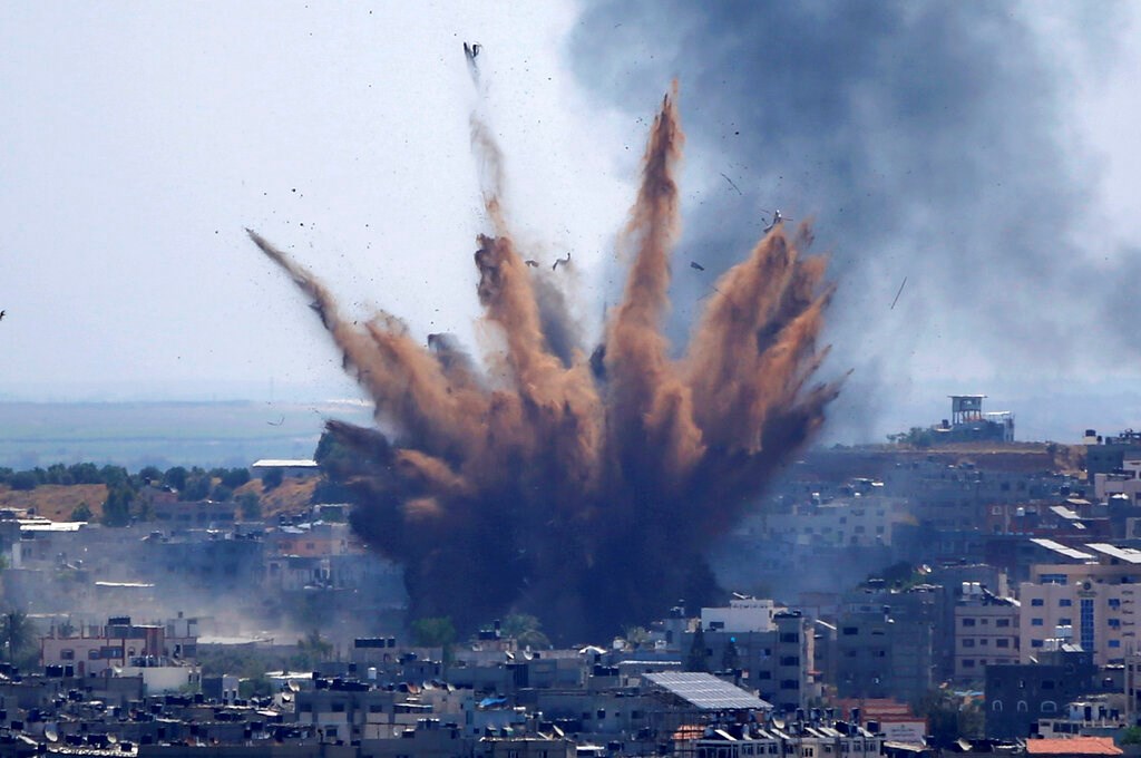 Smoke rises following Israeli airstrikes on a building in Gaza City on May 13, 2021.