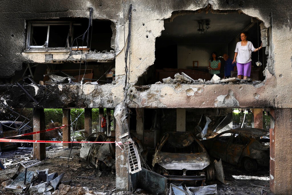 Members of the Sror family inspect the damage to their apartment in Petah Tikva in central Israel after it was hit by a rocket fired from the Gaza Strip on May 13, 2021.