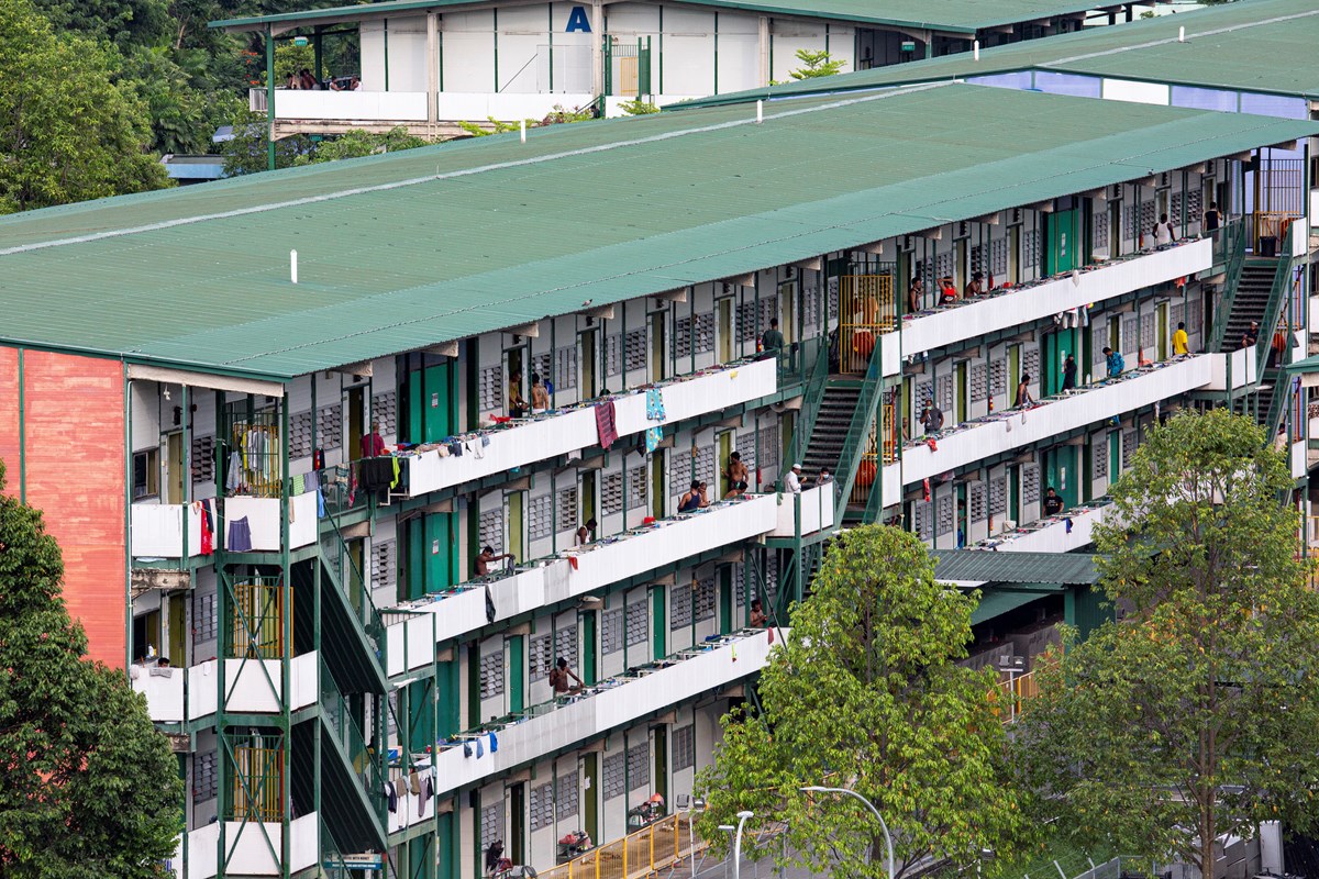 Migrant workers in Singapore at the Cochrane Lodge II, a purpose-built dormitory designated as an isolation area in April 2020. Migrant workers in Singapore at the Cochrane Lodge II, a purpose-built dormitory designated as an isolation area in April 2020.