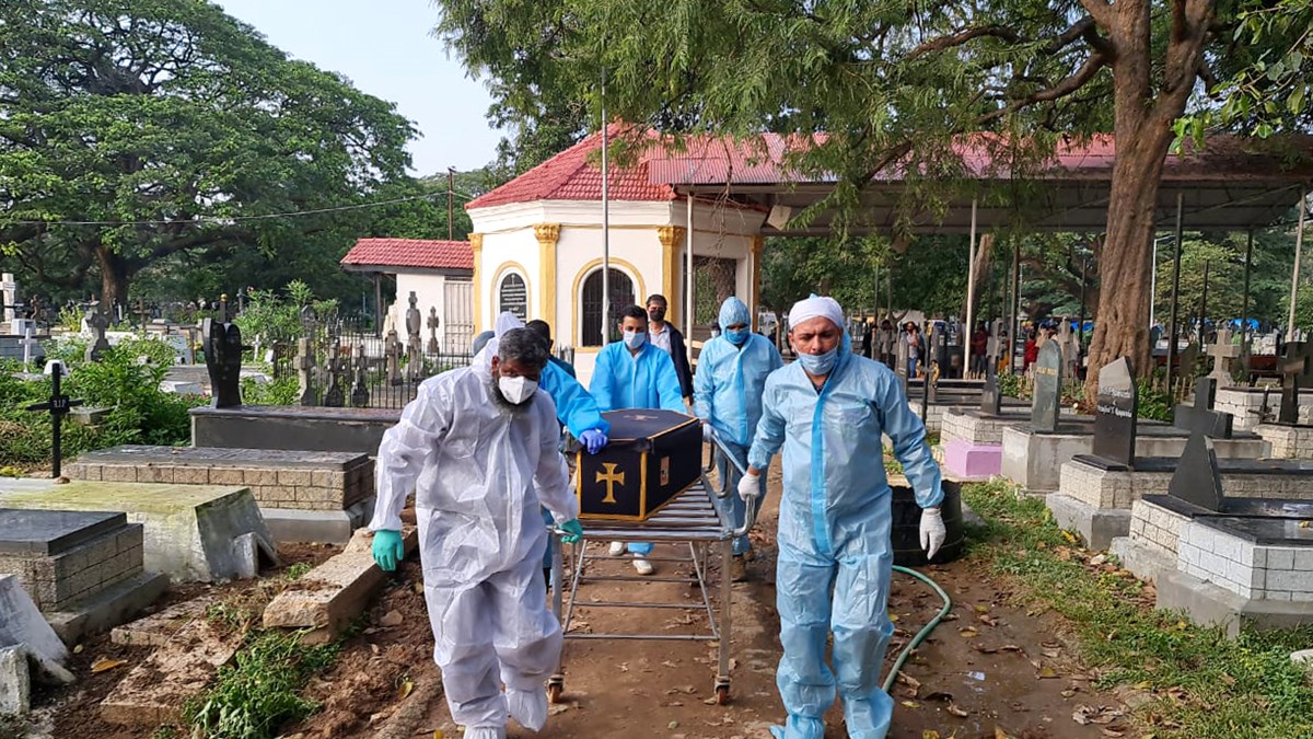 Volunteers with Mercy Mission in Bengaluru help bury deceased COVID-19 victims.