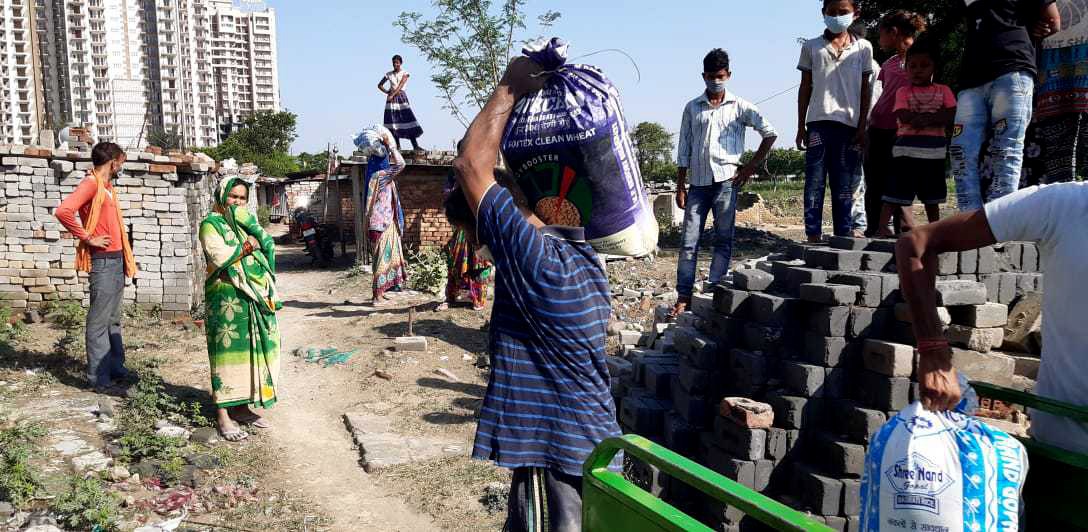 Volunteers distribute groceries to daily-wage workers in Delhi.