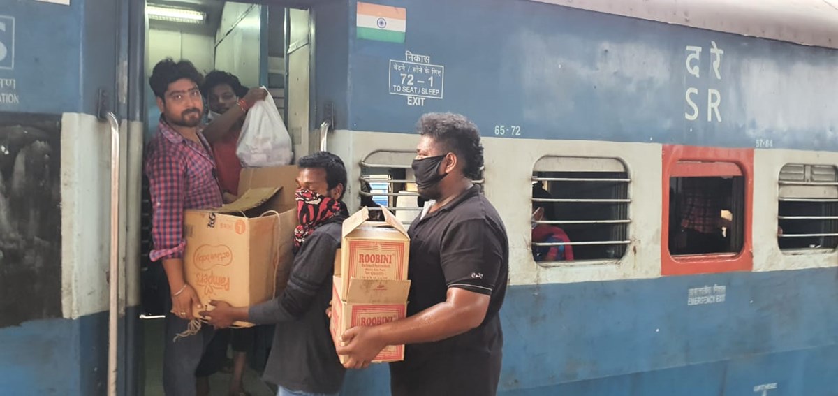 Volunteers distribute food to migrant laborers in Chennai.