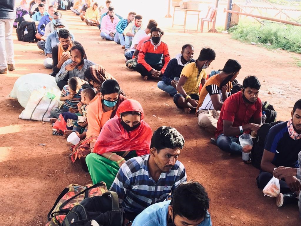 Migrant laborers with their food parcels in Bengaluru.