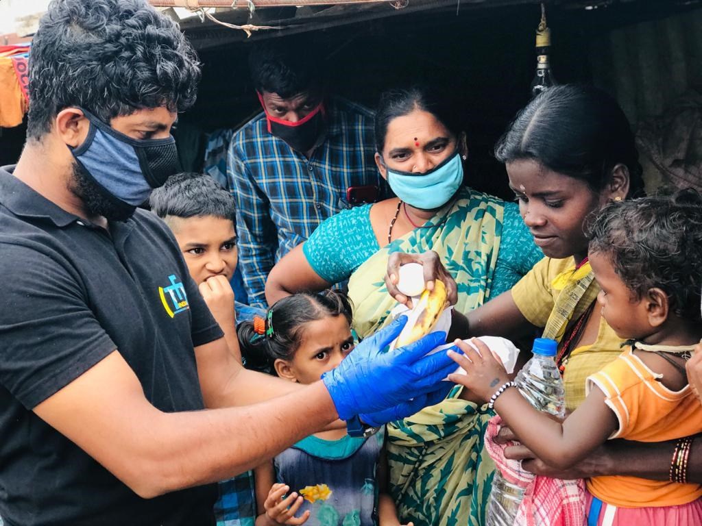 Volunteers distribute food to migrant laborers in Bengaluru.