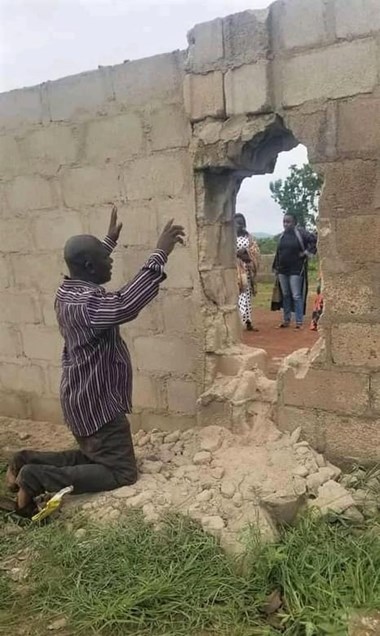 A parent prays for students abducted through a breached wall at Bethel Baptist High School in Kaduna, Nigeria, on July 5.