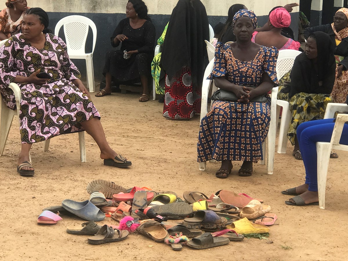 Parents wait for news by a pile of shoes left by their children abducted from Bethel Baptist High School in Damishi Kaduna, Nigeria, on July 6. Parents wait for news by a pile of shoes left by their children abducted from Bethel Baptist High School in Damishi Kaduna, Nigeria, on July 6.