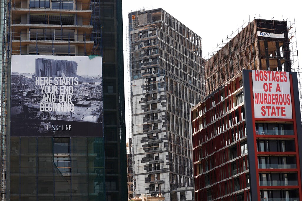 Banners hang on buildings damaged during last year's seaport explosion during a commemoration in Beirut, Lebanon on Wednesday, August 4, 2021. Banners hang on buildings damaged during last year's seaport explosion during a commemoration in Beirut, Lebanon on Wednesday, August 4, 2021.
