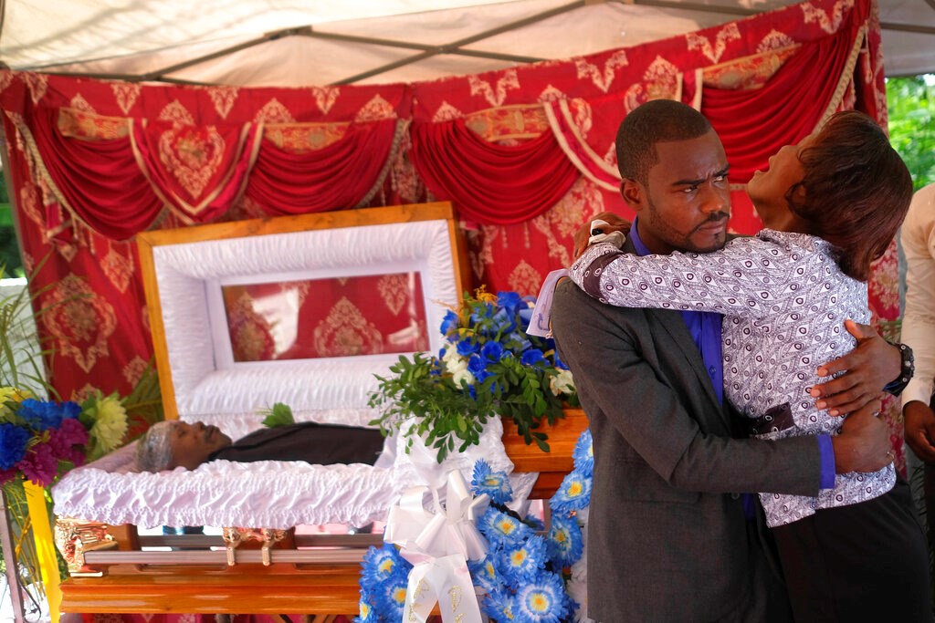 The son and mother of Baptist church minister Andre Tessono, who was killed during the 7.2 magnitude earthquake that hit the area eight days ago, mourn during his funeral in the Picot neighborhood in Les Cayes, Haiti, Sunday, Aug. 22, 2021. The son and mother of Baptist church minister Andre Tessono, who was killed during the 7.2 magnitude earthquake that hit the area eight days ago, mourn during his funeral in the Picot neighborhood in Les Cayes, Haiti, Sunday, Aug. 22, 2021.