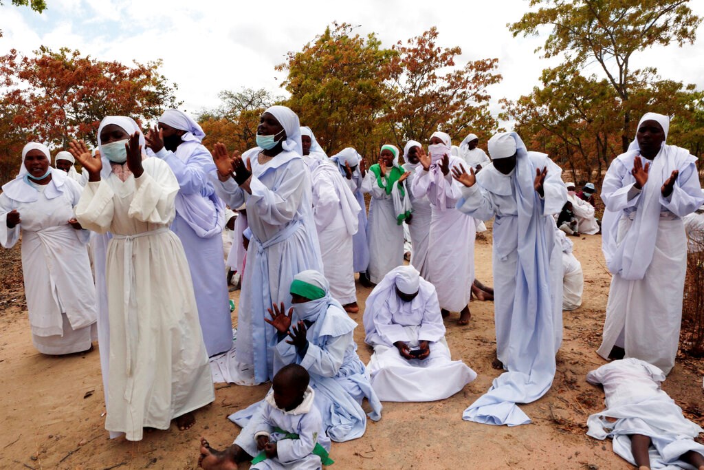 Members of an Apostolic Christian Church group gather for a prayer meeting on the outskirts of the capital Harare on September 10, 2021.