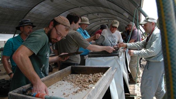 Volunteers sort through debris at the Temple Mount Sifting Project.