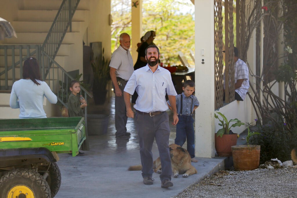 Unidentified people gather at the Christian Aid Ministries headquarters in Titanyen, north of Port-au-Prince, Haiti, on Thursday, December 16, 2021, after 12 hostage missionaries kidnapped two months ago were finally released.