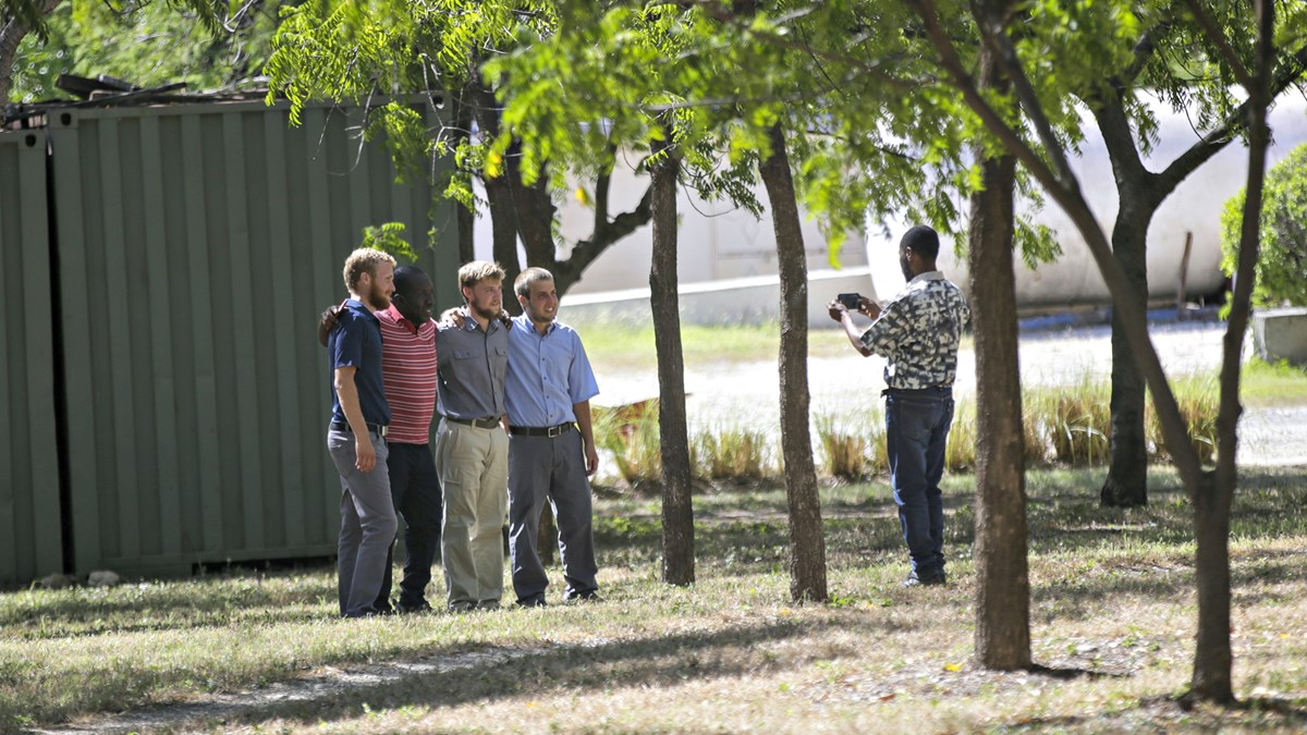 A man takes a photo of missionaries at the Christian Aid Ministries headquarters at Titanyen, north of Port-au-Prince, Haiti, on Thursday, December 16, 2021, after 12 hostage missionaries kidnapped two months ago were finally released.