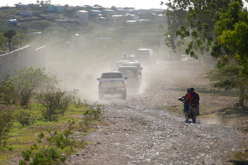 A caravan drives to the airport after departing from the Christian Aid Ministries headquarters at Titanyen, north of Port-au-Prince, Haiti, on December 16, 2021, after 12 hostage missionaries kidnapped two months ago were finally released.