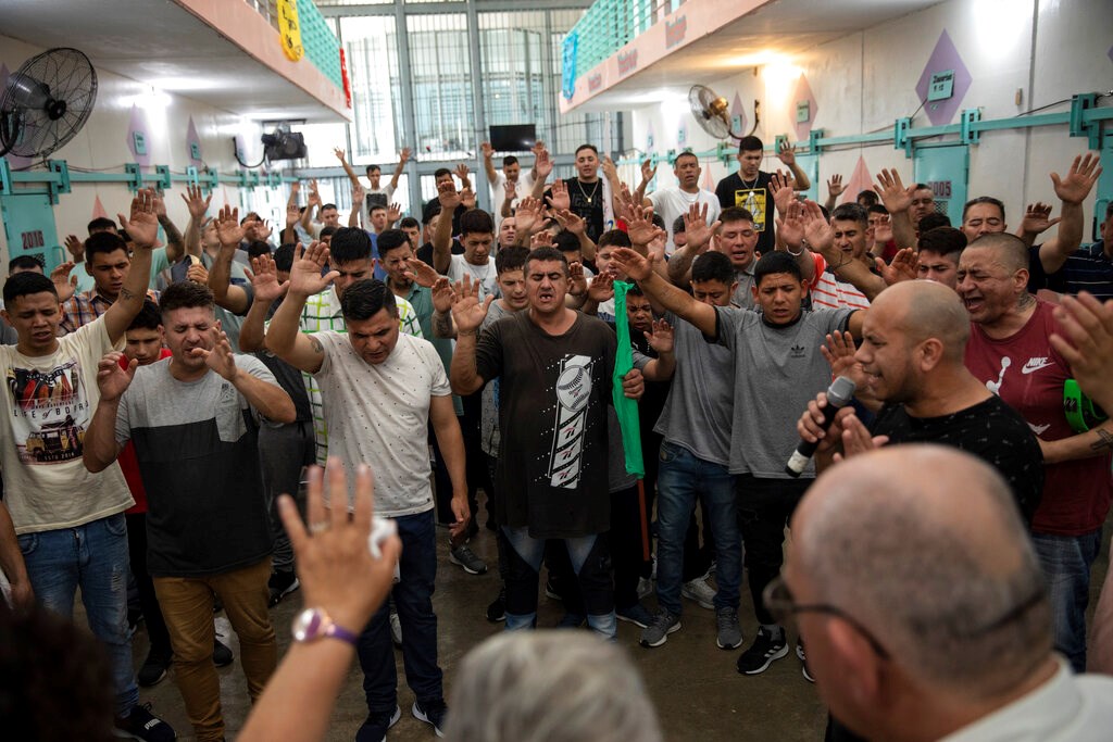 Prisoners pray inside an evangelical cellblock at the Penal Unit in Pinero, Santa Fe province, Argentina, Thursday, Nov. 4, 2021. Access to evangelical cellblocks is controlled both by prison officials and by cellblock leaders who function much like pastors.