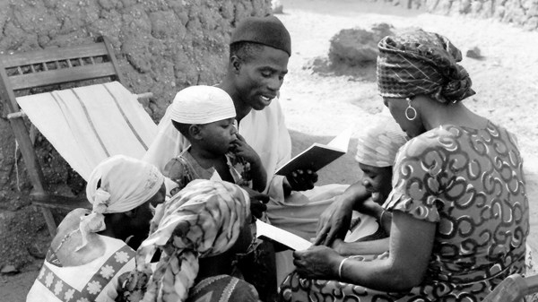 Family reading the Kamwe New Testament. Family reading the Kamwe New Testament.