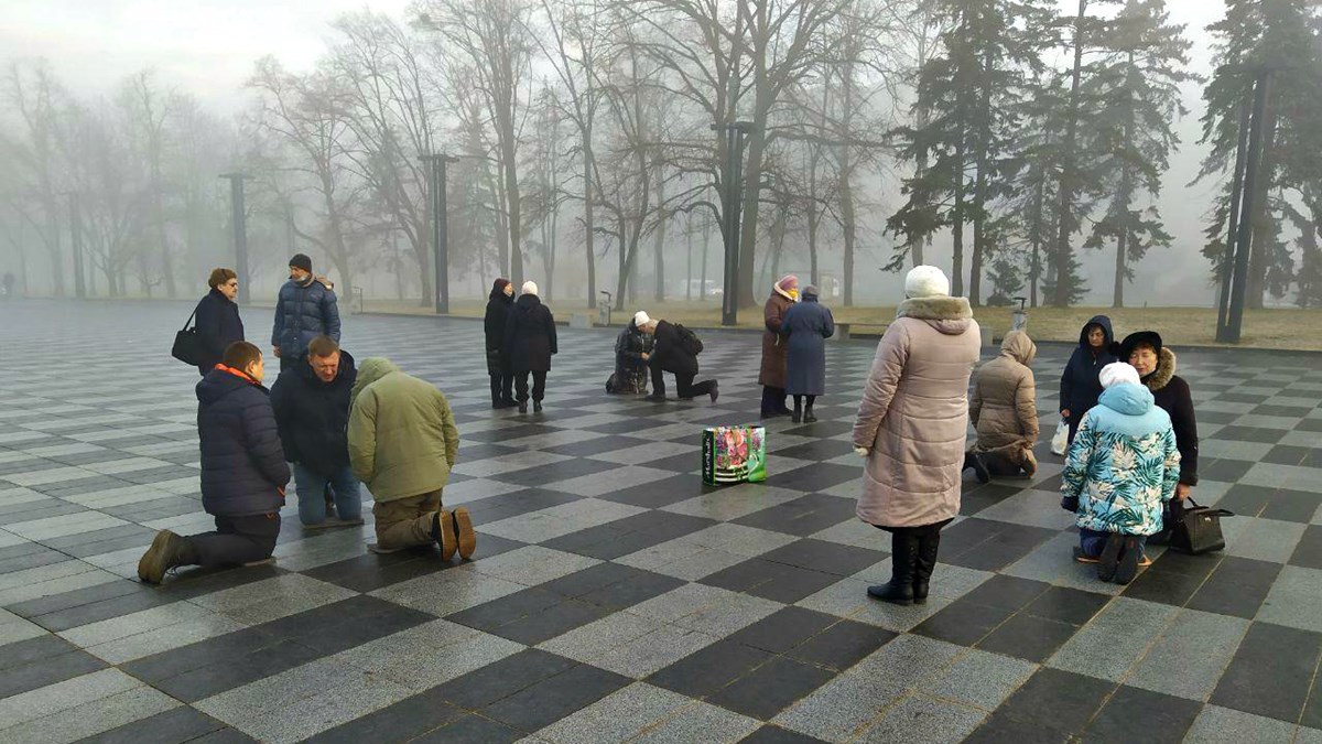 Ukrainians praying in the central square of Kharkiv, Ukraine.