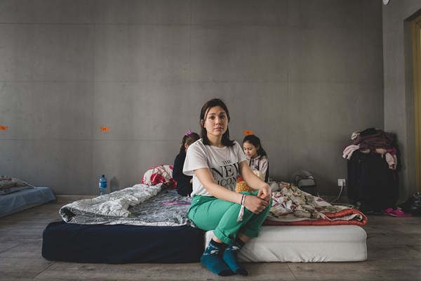 A Ukrainian mother and her children in  a shelter at a Pentecostal church in Warsaw.