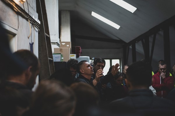 Oleksandr Demianenko prays before a meal at his warehouse in Warsaw.