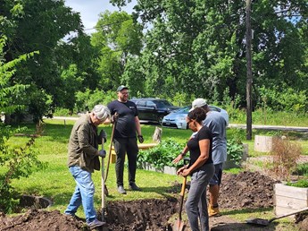 Volunteers work at the Northeast Houston Redevelopment Council's (NEHRC) community garden in Houston's Trinity Gardens neighborhood.