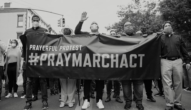 James Roberson (middle), the president of PMA, helps lead a march against racial injustice.