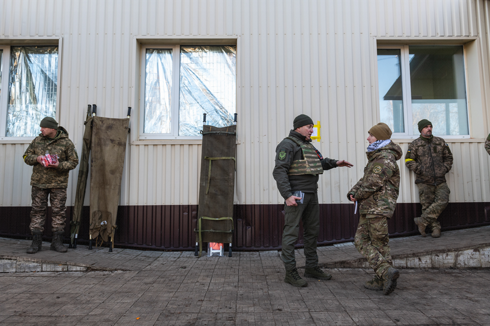 Evangelical chaplains at a stabilization point minister to the wounded and the medics with prayers and supplies.