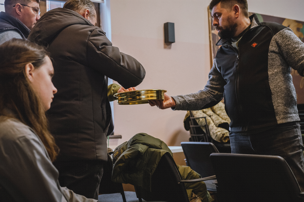 Evangelical ministers serve each other communion at a conference for volunteer chaplains.