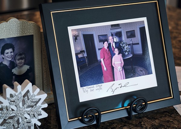 The Streges keep a picture of Hannah, her mother, and President George W. Bush from a visit to the White House in 2006.