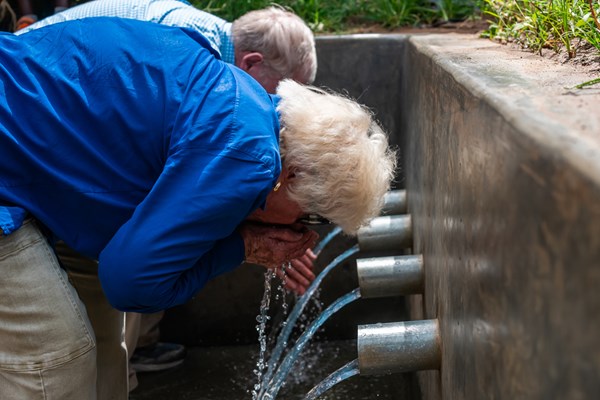 Ramon and Bob Billhimer drinking clean water in Uganda.