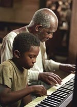Young Ray (C.J. Sanders) learning to play the piano