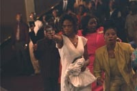 The movie literally starts with a bang, as Michelle (Kimberly Elise) pulls a gun in church