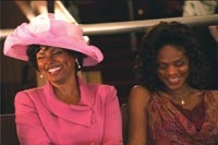 Twana (Debbie Morgan) and Michelle (Kimberly Elise) have a laugh at church