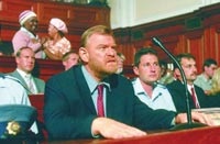 Brendan Gleeson as De Jager, testifying before the commission