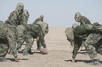The men sometimes pass the time by playing football in the desert heat—in full battle gear
