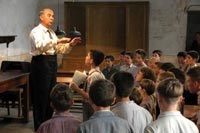 Gerard Jugnot, as Clement Mathieu, directs the boys choir