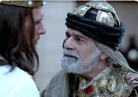 Omar Sharif as Prince Memucan, speaking with the king