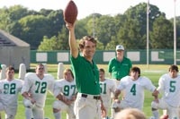 Lengyel holds a football aloft while giving a pep talk to the young Thundering Herd