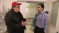 Filmmaker Michael Moore interviews a doctor