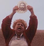 Adelfa (Lupe Ontiveros) holds the miraculous tortilla aloft